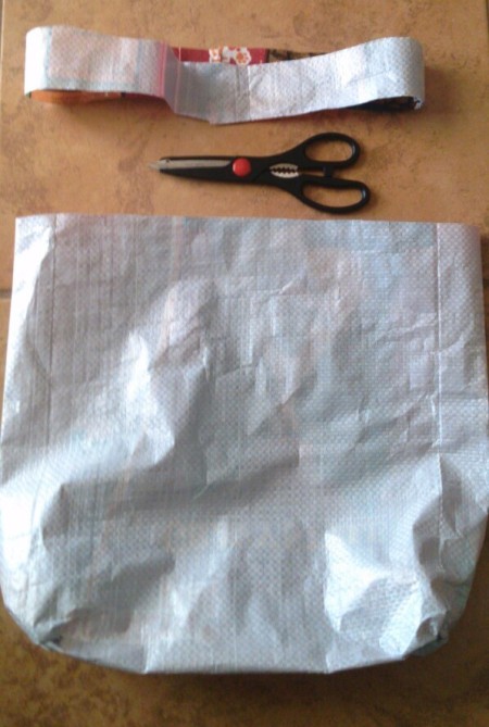 dog food bag turned inside out and strip cut off top to use for handles of tote bag