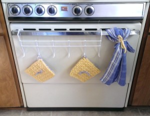 hot pads and towel hanging on oven door