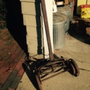 mower leaning on garage