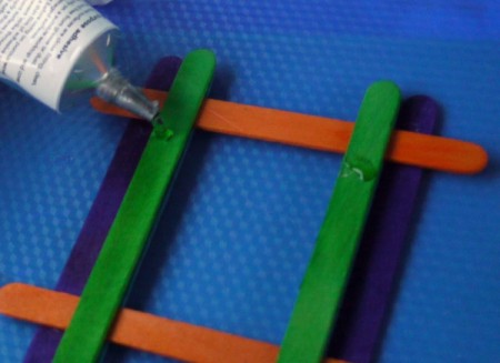 gluing the red sticks onto the green ones