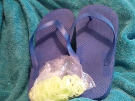 A pair of flip flops and a bag of rubber bands.