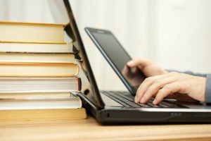 A student using a computer and tablet.