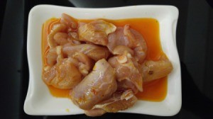 A plate of marinated chicken ready to be cooked.