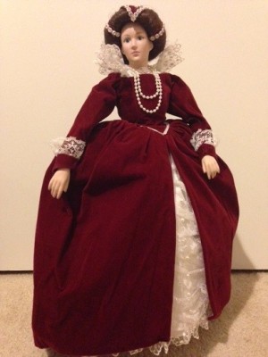 doll in fancy dark red dress over petticoats