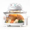 Close up image of an electronic countertop convection oven containing a baked chicken and vegetables against a white background