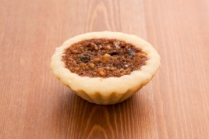 Small butter tart on a wooden surface.