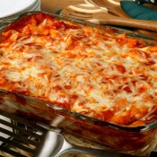 Glass rectangular pan on baked ziti cooling on electric stove top