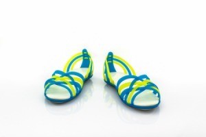 Yellow and blue strappy sandals against a white background