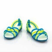 Yellow and blue strappy sandals against a white background