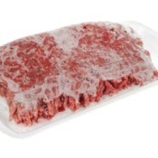 Frozen hamburger in packaging against white background