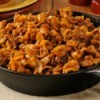 Hamburger, noodle and red sauce casserole in a cast iron skillet