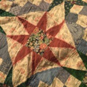 Closeup of quilt showing where red color bled into surrounding light colored fabric