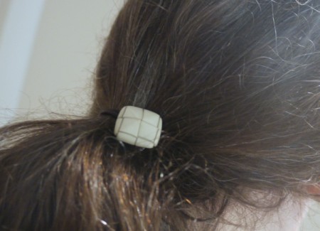 button hair tie in hair