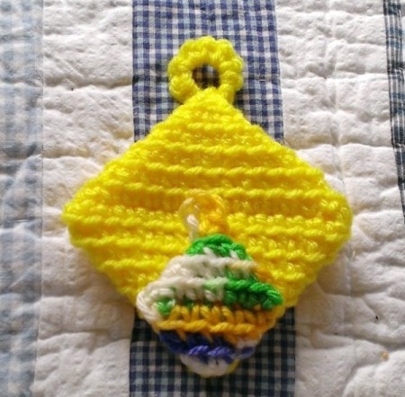 two small crochet hot pad magnets