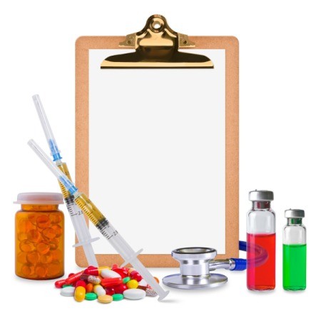 Medical supplies surrounding a clipboard with blank page