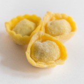 Three tortellini pasta on a white background