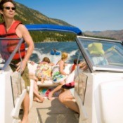 Family on a motor boat watching watching someone waterski