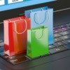 Three tiny gift bags standing on a laptop keyboard