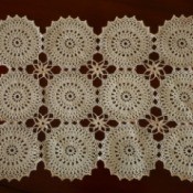 Vintage crochet placemat against red background