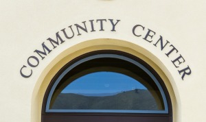 Arched window on a building with the words "Community Center"