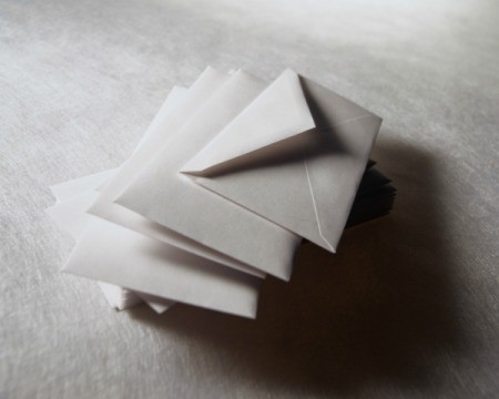 Sepia tint image of a stack of white envelopes