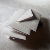 Sepia tint image of a stack of white envelopes
