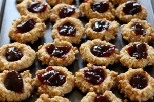 Thumbprint cookies with jam filling on a cookie sheet
