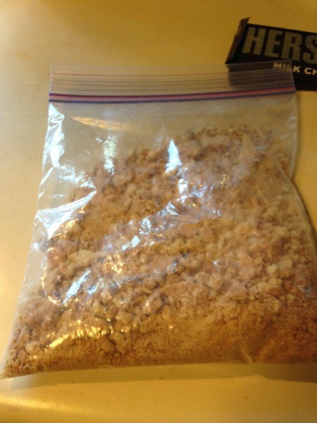 Crushed graham crackers in a plastic bag.