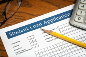 Close up image of student loan application with pencil and calculator