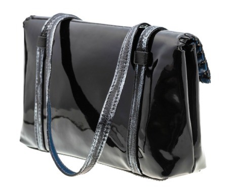 Black patent leather purse against a white background