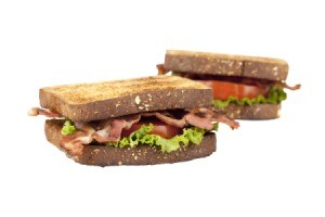 Two BLTs (Bacon Lettuce Tomato Sandwiches) against a white background