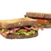 Two BLTs (Bacon Lettuce Tomato Sandwiches) against a white background
