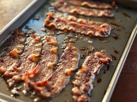 Oven cooked bacon on cookie sheet.