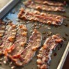 Oven cooked bacon on cookie sheet.