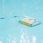 Close up of an automated swimming pool vacuum on the pool floor