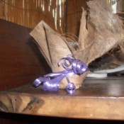 fiber wrapped glass with purple ribbon tied around