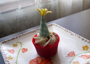 cupcake topped with paper party hat decoration