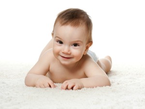 Diapered baby on carpet.