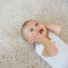 Baby on carpet.