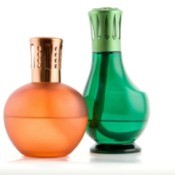 Two colored glass fragrance lamps consistent with the style sold by Lampe Berger