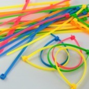 Several colors of cable ties against a white background