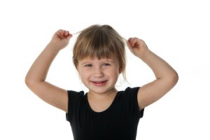 Young girl pulling on her hair