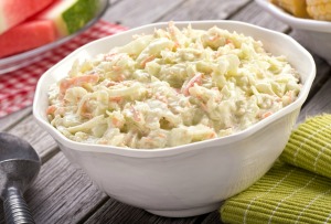 Close-up of a bowl of coleslaw on a picnic table