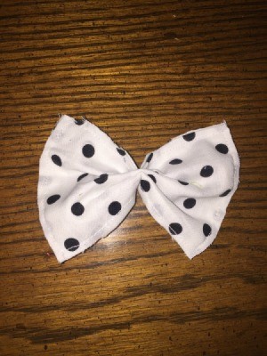 white fabric bow with black polka dots