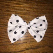 white fabric bow with black polka dots