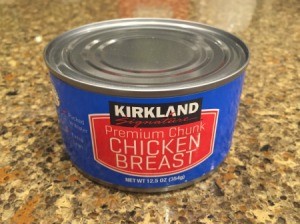 Tin of canned chicken on a granite countertop