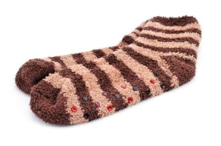 A pair of fuzzy socks with rubber dots on the bottom to help stop slipping