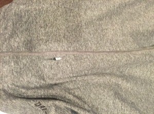 Close up of a small hole in a grey t-shirt