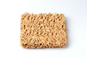 Rectangle of dry ramen noodles on a white background