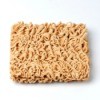 Rectangle of dry ramen noodles on a white background